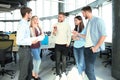 Full length of young people in smart casual wear discussing business and smiling while walking through the office. Royalty Free Stock Photo