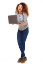 Full length young woman laughing with laptop computer by isolated white background Royalty Free Stock Photo