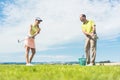 Young woman practicing the correct move during golf class