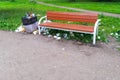 Full litter bin in the park next to the bench Royalty Free Stock Photo