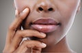 Full lucious lips. Closeup of an African-American woman touching her mouth.