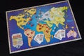 Full map of classic risk strategy board game in spaninsh with small figures dices and cards