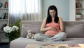 Full of maternal instincts woman gently touching her beloved pregnant tummy Royalty Free Stock Photo