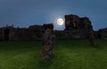 The full moon of Aberytwyth over the ruins of an ancient castle. Royalty Free Stock Photo