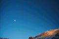 full moon above a ridgeline in a starlit sky Royalty Free Stock Photo