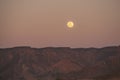 Full moon above ridge