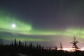 Full Moon and active colorful aurora over Fairbanks Alaska