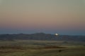 Full moon ascends over the dune in Namib desert Namibia