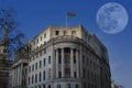 A full moon behind South Africa House overlooking Trafalgar Square in London Royalty Free Stock Photo