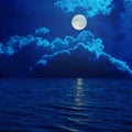 Full moon in clouds over sea Royalty Free Stock Photo