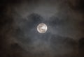 Full moon on cloudy black sky