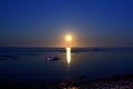 The full moon comes out of the sea Royalty Free Stock Photo