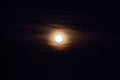 Full moon in the dark night sky with clouds, closeup of photo.Full moon in the dark night sky Royalty Free Stock Photo