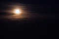 Full moon in the dark night sky with clouds, closeup of photo.Full moon in the dark night sky Royalty Free Stock Photo