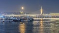 Full moon on goldenhorn with metro bridge, mosque, old town and trip boats in winter s
