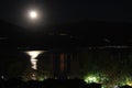 Full moon at lake Pamvotis with background Pindus mountain range. Ioannina, Epirus, Greece Royalty Free Stock Photo