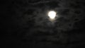 Full moon at night with cloud real time. 4k video full moon in the black sky. Clouds passing by moon at night. night sky with clo