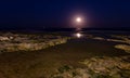 The full moon over the Mediterranean on the rocky coast of Torrevieja. Royalty Free Stock Photo