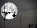 full moon in night sky and silhouette top of lantern pilla