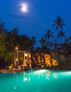 Full moon night view of a swimming pool on a beautiful resort at Royalty Free Stock Photo