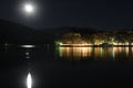Full moon at lake Pamvotis and Ioannina city with background Pindus mountain range. Epirus, Greece Royalty Free Stock Photo
