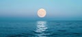 Full moon over blue sea water in pastel sky, nature background Royalty Free Stock Photo