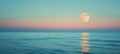 Full moon over blue sea water in pastel sky Royalty Free Stock Photo