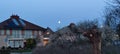 Full moon over a city neightbourhood Royalty Free Stock Photo