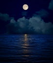 full moon over clouds and dark water Royalty Free Stock Photo