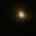 Full moon over dark black sky at night. Mysterious concept with clouds, fog and moon