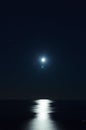 Full moon over dark water with reflections on it Royalty Free Stock Photo