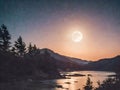 Full moon over a mountain lake in the mountains at night. Royalty Free Stock Photo