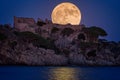 Full moon over the old castle in Costa Brava in a holiday village Fosca , Spain Royalty Free Stock Photo