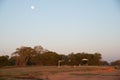 Full moon over public park near row of shade structure pavilion at Grapevine Lake, Texas, US, sandy shoreline with first Royalty Free Stock Photo