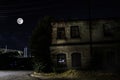 Full moon over quite village at night. Beautiful night landscape of old town street with lights. Russia Royalty Free Stock Photo