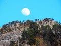 A full moon over the rocky alpine peak of Musflue in the Swiss mountain range of Pilatus and in the Emmental Alps, Alpnach Royalty Free Stock Photo