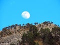 A full moon over the rocky alpine peak of Musflue in the Swiss mountain range of Pilatus and in the Emmental Alps, Alpnach Royalty Free Stock Photo