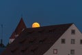 Full moon over the roofs and towers of Regensburg, Germany