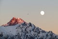 Full moon and bird over snowy mountain at sunset Royalty Free Stock Photo