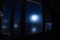 Full moon over the valley in window view. Fisheye lens shot wind angle