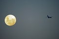 FULL MOON AND PASSING JET