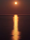 Full moon reflecting in the calm sea at night time Royalty Free Stock Photo
