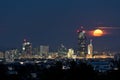 Full moon rises over downtown Vienna