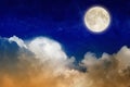 Full moon rising above glowing clouds in night sky Royalty Free Stock Photo