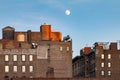 Full moon rising above old brick buildings around Union Square P