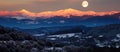 Moon rising over snowy mountain range under cloudfilled sky Royalty Free Stock Photo