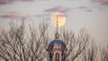 Full moon rising behind a beautiful building with a white steeple. Garden City, New York Royalty Free Stock Photo