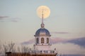 Full moon rising behind a beautiful building with a white steeple. Garden City, New York Royalty Free Stock Photo