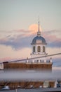 Full moon rising behind a beautiful building with a white steeple. Garden City, New York Royalty Free Stock Photo