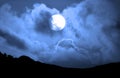Full Moon rising behind some clouds clouds Royalty Free Stock Photo